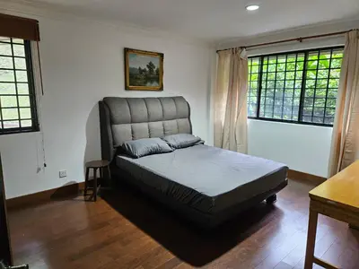 a bedroom with a bed and two windows at X'Apartelle near Pusat Bandar Damansara MRT in Kuala Lumpur