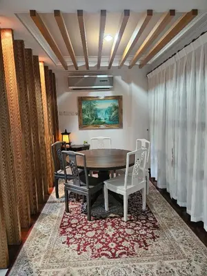 a dining room with a table and chairs at X'Apartelle near Pusat Bandar Damansara MRT in Kuala Lumpur