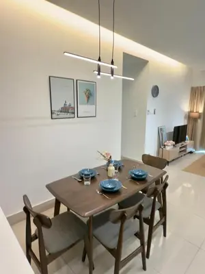 a dining room table and chairs in a living room at Razak Residence B2-43 RC Kuala Lumpur in Kuala Lumpur