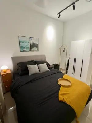 a bedroom with a large bed with a yellow blanket at Razak Residence B2-43 RC Kuala Lumpur in Kuala Lumpur