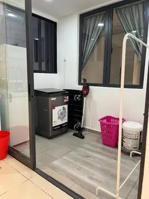 a living room with a door open to a room with a window at NaBella Homestay LSH33 Sentul in Kuala Lumpur
