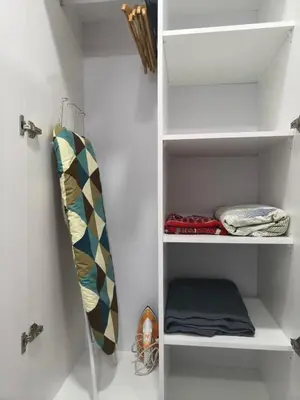 a closet with white shelves and a surfboard on it at NaBella Homestay LSH33 Sentul in Kuala Lumpur