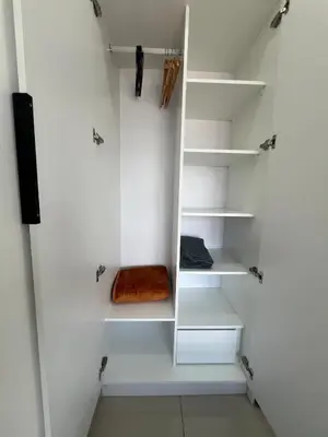 a walk in closet with white shelves at NaBella Homestay LSH33 Sentul in Kuala Lumpur