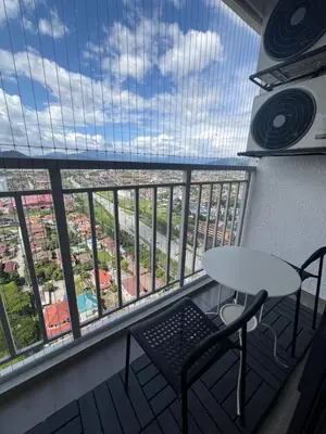 a balcony with a table and chairs and a view at NaBella Homestay LSH33 Sentul in Kuala Lumpur