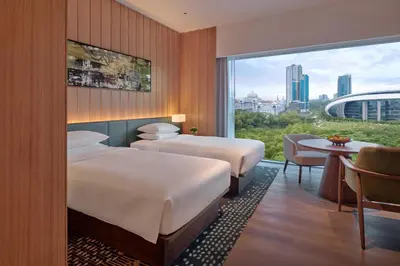 a hotel room with two beds and a window at Hyatt Regency Kuala Lumpur at KL Midtown in Kuala Lumpur