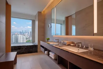 a bathroom with two sinks and a large mirror at Hyatt Regency Kuala Lumpur at KL Midtown in Kuala Lumpur