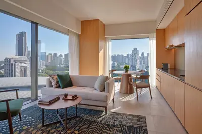 a living room with a couch and a large window at Hyatt Regency Kuala Lumpur at KL Midtown in Kuala Lumpur