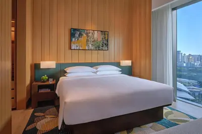 a bedroom with a large bed and a large window at Hyatt Regency Kuala Lumpur at KL Midtown in Kuala Lumpur