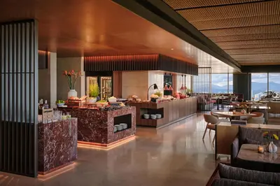 a restaurant with a bar and tables and chairs at Hyatt Regency Kuala Lumpur at KL Midtown in Kuala Lumpur