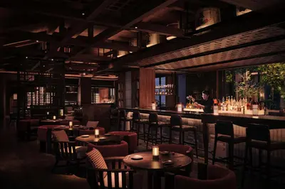 a restaurant with tables and chairs and a bartender at Hyatt Regency Kuala Lumpur at KL Midtown in Kuala Lumpur