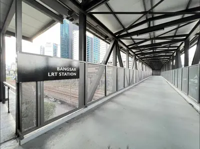 a walkway in a building with a sign that reads embassy left station at KL Sentral Service Apartment-The Establishment KL Sentral EST in Kuala Lumpur