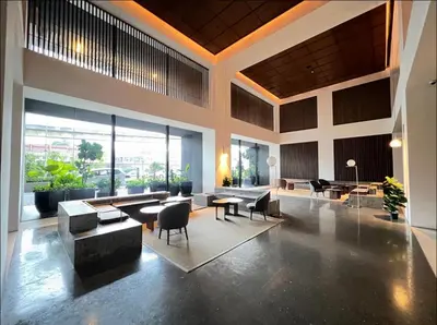 a lobby with couches and chairs and tables and windows at KL Sentral Service Apartment-The Establishment KL Sentral EST in Kuala Lumpur