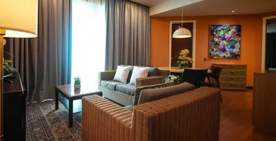 a living room with a couch and a table at Acappella Kuala Lumpur City Centre in Kuala Lumpur