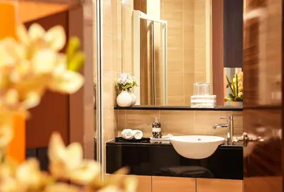 a bathroom with a sink and a mirror at Acappella Kuala Lumpur City Centre in Kuala Lumpur