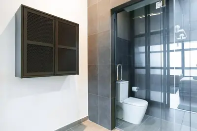 a bathroom with a toilet and a glass shower at ASTORIA Ampang Apt Designer Condo in Kuala Lumpur