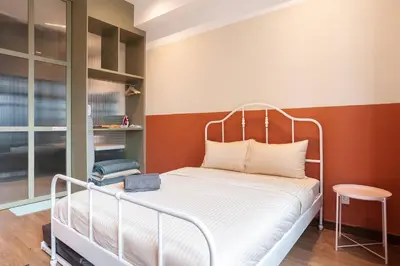 a bedroom with a bed with a metal bed frame at ASTORIA Ampang Apt Designer Condo in Kuala Lumpur