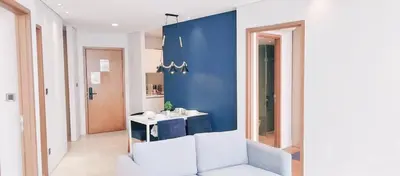 a bathroom with a white sink and a blue wall at Vortex KLCC by Family Suites in Kuala Lumpur