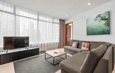 a living room with a couch and a flat screen tv at Vortex KLCC by Family Suites in Kuala Lumpur