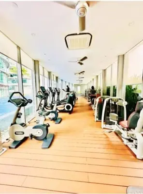 a gym with a row of treadms and machines at Vortex KLCC by Family Suites in Kuala Lumpur