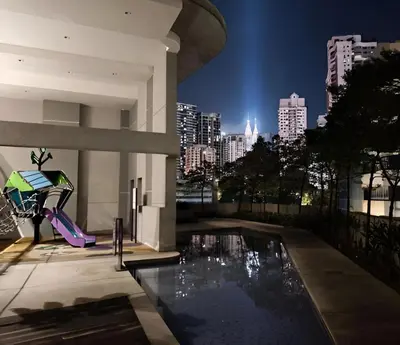 a building with a swimming pool with a city skyline at The Robertson by Kuala Lumpur in Kuala Lumpur