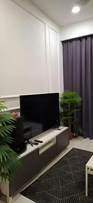 a living room with a flat screen tv on a table at The Robertson by Kuala Lumpur in Kuala Lumpur