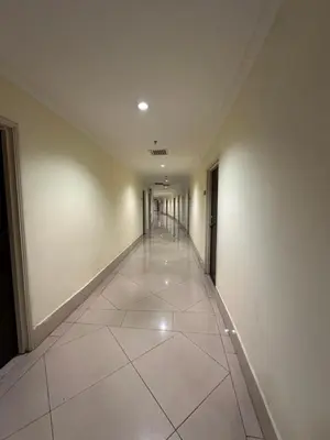 an empty hallway in a building with a tile floor at Parkview 2bedroom apartment klcc in Kuala Lumpur