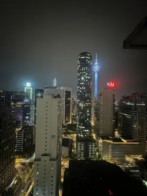 a city lit up at night with tall buildings at Parkview 2bedroom apartment klcc in Kuala Lumpur