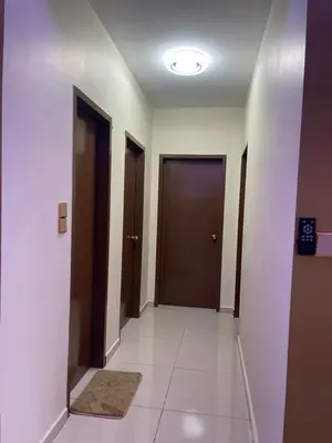 a hallway with two doors and a tile floor at Vista Sentul Residence in Kuala Lumpur