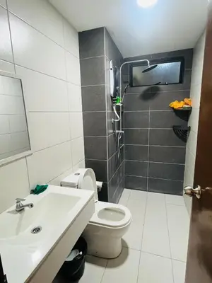 a bathroom with a toilet and a sink at Vista Sentul Residence in Kuala Lumpur