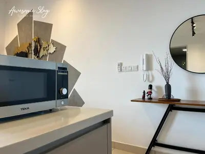 a tv sitting on a counter in a room at Trion KL By Holidayhome in Kuala Lumpur
