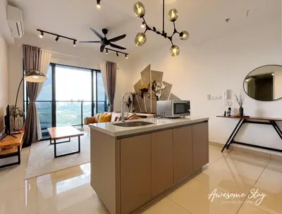 a kitchen with a sink and a living room at Trion KL By Holidayhome in Kuala Lumpur