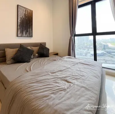 a bed in a bedroom with a large window at Trion KL By Holidayhome in Kuala Lumpur