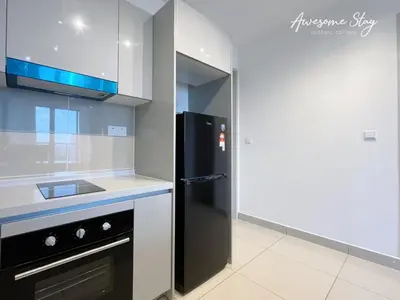 a kitchen with a black refrigerator and a sink at Trion KL By Holidayhome in Kuala Lumpur