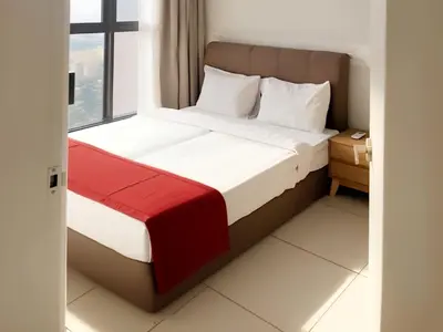 a bed in a hotel room with a window at Trion KL Service Suite - Modern City Stay with Pool & Gym in Kuala Lumpur