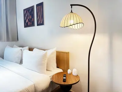 a bedroom with a bed and a lamp and a table at Cozy Studio I Riveria City I 1km to KL Sentral in Kuala Lumpur