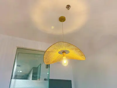 a yellow umbrella light hanging from a ceiling at Cozy Studio I Riveria City I 1km to KL Sentral in Kuala Lumpur