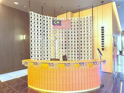 a lobby with a podium with an american flag on it at Majestic Alaman Suites KLCC in Kuala Lumpur