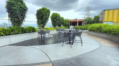 a group of chairs and tables on a patio at Majestic Alaman Suites KLCC in Kuala Lumpur