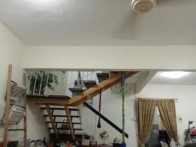 a living room with a spiral staircase in a house at have fun staying here in Kuala Lumpur