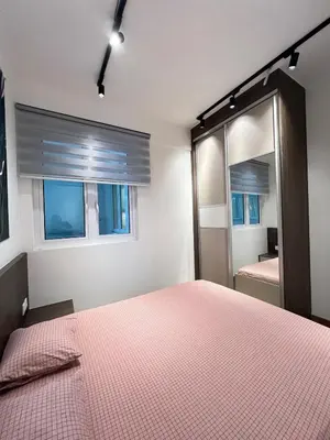 a bedroom with a pink bed and a mirror at Relax and Enjoy ! in Kuala Lumpur