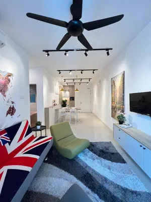 a living room with a ceiling fan and a green chair at Relax and Enjoy ! in Kuala Lumpur