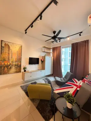 a living room with a couch and a ceiling fan at Relax and Enjoy ! in Kuala Lumpur
