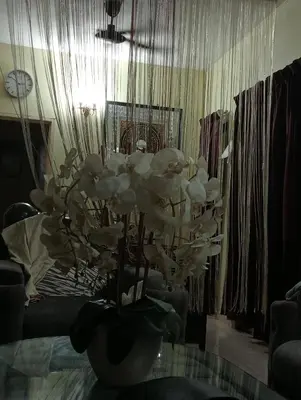 a vase filled with white flowers on a table at have fun staying here in Kuala Lumpur