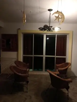 a living room with chairs and a large window at have fun staying here in Kuala Lumpur
