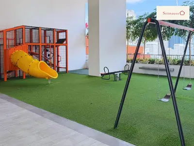 a room with a playground with a slide at KLCC View & Netflix & Walk to LRT & Sunway Putra in Kuala Lumpur