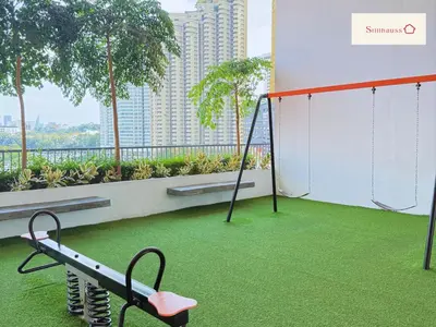 a swings on a balcony with a view of a city at KLCC View & Netflix & Walk to LRT & Sunway Putra in Kuala Lumpur