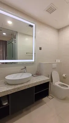 a bathroom with a sink and a toilet and a mirror at Star Residence KLCC By LLKOK in Kuala Lumpur