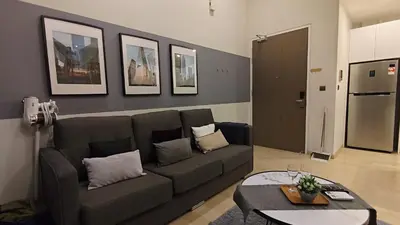 a living room with a couch and a table at Star Residence KLCC By LLKOK in Kuala Lumpur