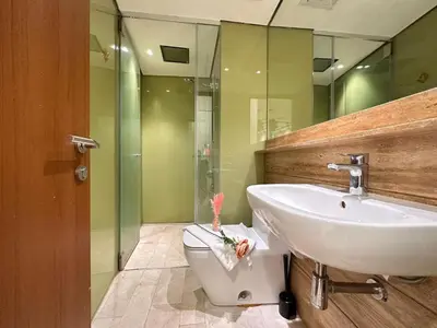 a bathroom with a sink and a toilet at Sky Suites in Kuala Lumpur