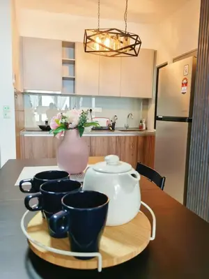 a kitchen with a table with cups and a vase at M VERTICA Isyak Homestay in Kuala Lumpur